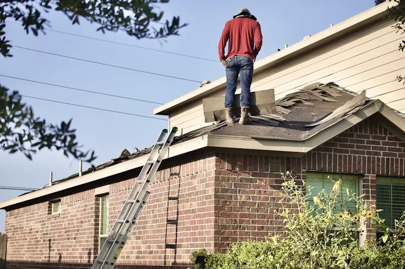 Professional roofer working on a residential roof in Livonia